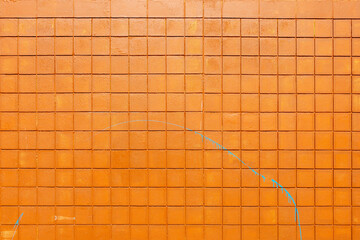 An abstract image of an exterior building wall constructed from small square orange bricks.  - obrazy, fototapety, plakaty