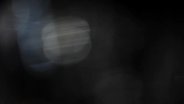 Bokeh Light Flares. Abstract light effects on a dark background with round colorful bokeh.