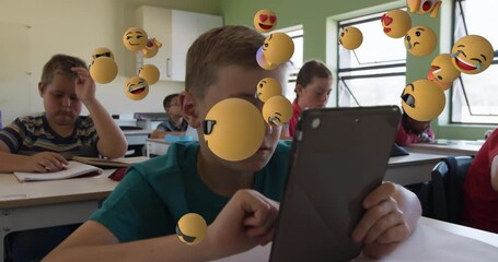 Animation of multiple emoticons floating over diverse students studying and using digital tablet - Powered by Adobe