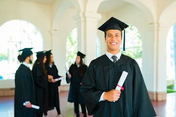 Cheerful latin man happy after graduating university
