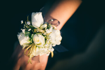 Close up of floral bouquet worn around wrists