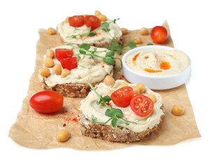 Delicious sandwiches with hummus and ingredients on white background