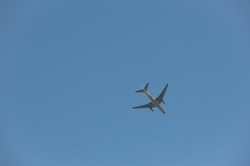 A plane flying across the clear sky.