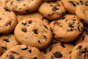 Delicious chocolate chip cookies as background, closeup