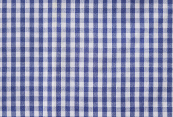 Blue checkered tablecloth as background, top view
