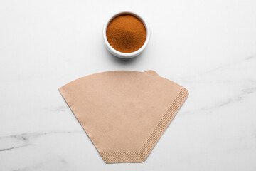Paper filter and instant coffee on white marble table, flat lay