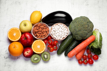 Almonds, beans, fresh fruits and vegetables on light grey textured background, flat lay. Low glycemic index diet