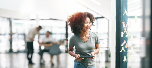 Young ethnic businesswoman creative team using sticky notes in glass wall to writing strategy business plan to development grow to success.