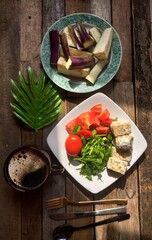Vegetable salad and coffee on wood background 