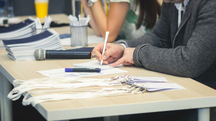 Registration desk table, process of checking in on a conference congress forum event, visitors and...