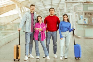 Fototapeta na wymiar Two Couples Going On Vacation Standing With Suitcases In Airport