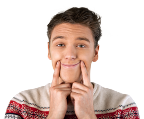 Young man puts his hands to his face and with his fingers pushes his cheeks up to produce a smile, Isolated