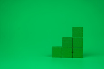 Stack of empty green blocks with free space for you text on a green background