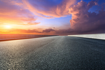 Asphalt highway and sky sunset clouds background