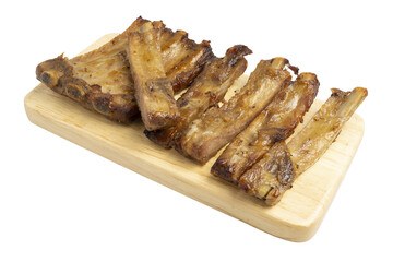 Homemade Roasted Honey Glazed Rack and Pieces of Pork Ribs, famous for Octoberfest party dinner serving on wooden board.