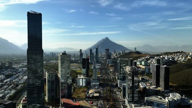 Aerial view of the city center of San Pedro Garza Garcia, sunny Monterrey, Mexico - reverse, drone shot