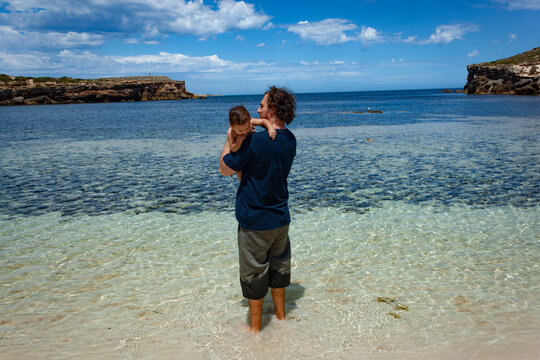 Full frame shot of father and son with the cliffs of Pondalowie Bay in the background at Innes National Park, Australia.