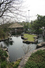 Fototapeta na wymiar Asian theme garden with pond and memorial