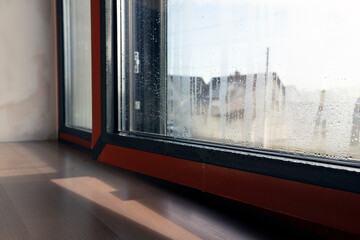 Close up of double glazed window condensation causes by excessive moisture in the house in winter occurs when the seal between panes is broken or desiccant inside the window.
