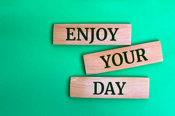 Wooden blocks with words 'Enjoy your day'.