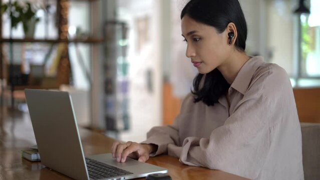 Asian freelancer office cafe. Busy person use computer macbook coworking place. Boss woman looking screen monitor. People study network. Female user start up laptop desk. Coworker girl job home space.