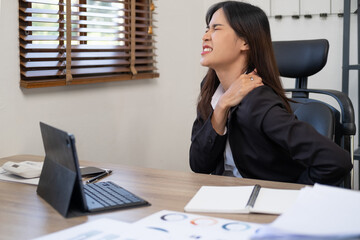 Beautiful Asian office woman having an office syndrome problem. Health problem in office and working lifestyle.