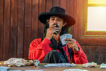 Cowboys are relaxing by gambling and smoking,which are very bad for their helth.