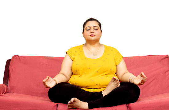 Overweight Indian Woman Doing Yoga Mediation At Home 