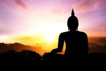 Silhouette of Buddha on mountain in sunset light