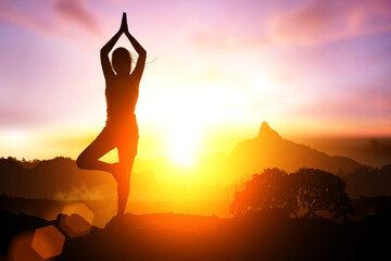 Silhouette ASilhouette Asia woman yoga on sunset.sia woman yoga on sunset.