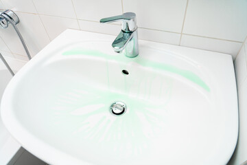 Cleaning plumbing with cleaning products, glove sponge and plumbing.