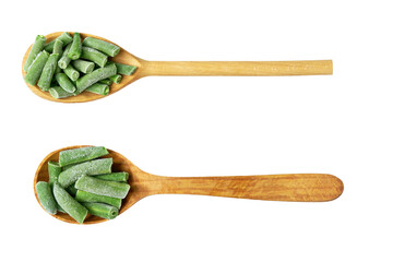 frozen green beans in a wooden spoon isolated on white background, top view.