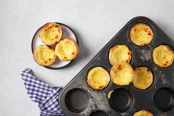 Pasteis de nata, typical Portuguese egg tart pastries from Lisbon in the cooking form. Top view