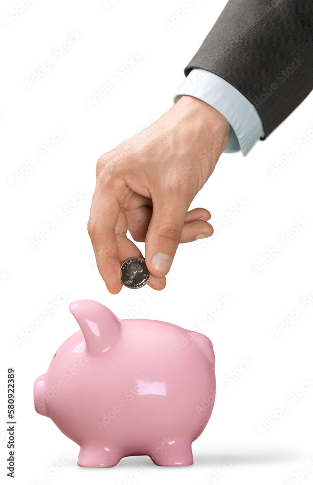 Wall mural businessman putting coin into the piggy bank