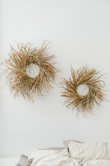 Wreaths of dry grass. Interior decor. Panel on the wall. Boho style. Sedge. White background.