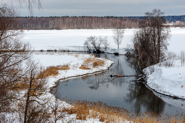 The bend of the spring river in March