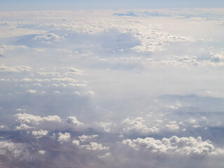 Fototapeta na wymiar Clouds above the earth as a background. View from the airplane window.