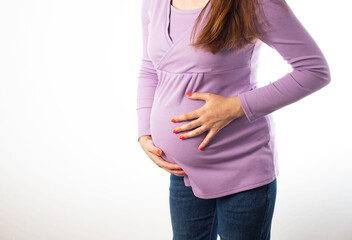 Pregnant girl holding on to her swollen belly on a white background. The concept of flatulence and...