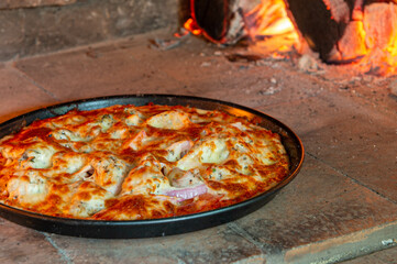 Closeup of pizza in the wood fire oven