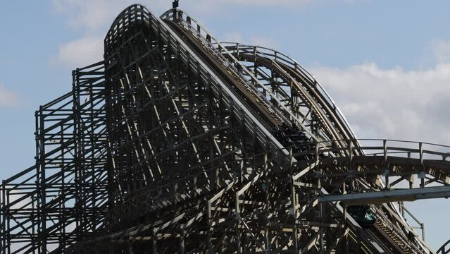 The roller coaster with the train climbing towards to the top head
