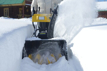 Removal from snow the path and the territory of the courtyard of the house with the help of a snow...
