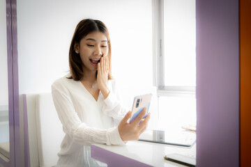 Fototapeta premium Beautiful asian businesswoman excited about big bonus at work.