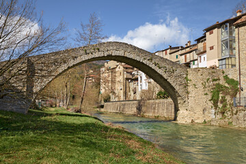 Fototapeta premium Portico di Romagna, Forli-Cesena, Emilia-Romagna, Italy: the ancient humpback bridge over the Montone river in the picturesque village on the Apennine mountains