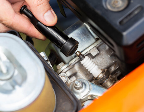 Replacing the spark plug in the motor block engine cylinder. Maintenance of the ignition system. Close-up