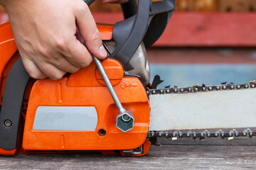 Correct chain tension using the special tool on the chainsaw bar. Chain tension adjustment.
