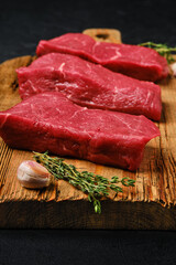 Closeup view of raw beef steak on cutting board