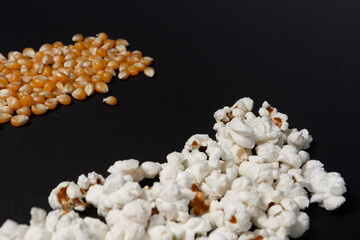 Corn and popcorn grains in two rows on a black background.