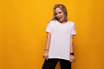 blond woman in white tank top with blank space on yellow background