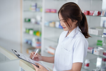 Asian woman pharmacist working at Pharmacy Drugstore . Medical healthcare concept