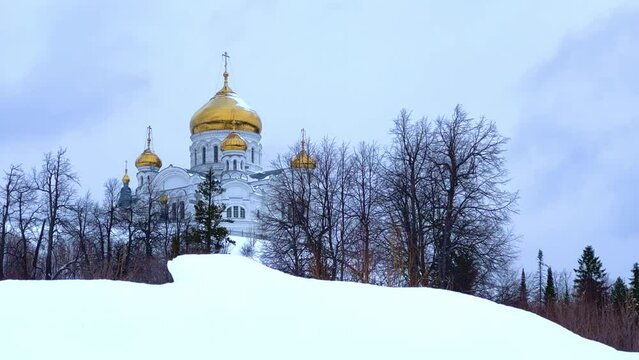 Belogorsky St. Nicholas Orthodox Missionary Monastery. Russia, Perm Krai, Belaya Gora. The temple on the hill in winter. Monastery on the background of snow. 4K